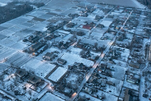 View of the village from a height small private houses glowing in the evening winter landscape