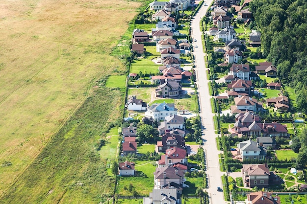 Above view of village near harvested field