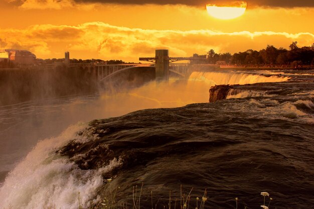 View of waterfall at sunset