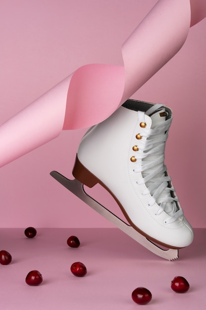 Photo view of white ice skates with cherries