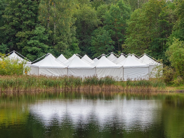 A view of the white tents by the water.