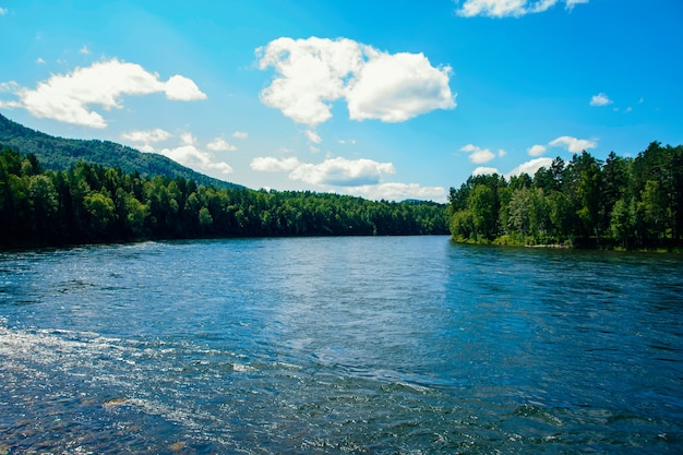 Photo view of a wide mountain river in summer