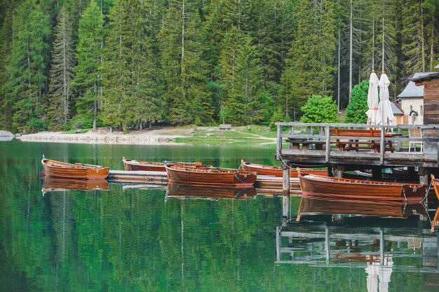 View of wooden dock boats station at braies lake in Italy