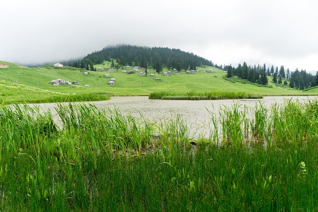 View of a wooden mountain cabin with mountains in the background