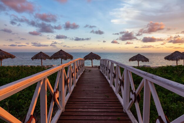 View of a wooden path leading to the sandy beach on the Caribbean Sea in Cuba