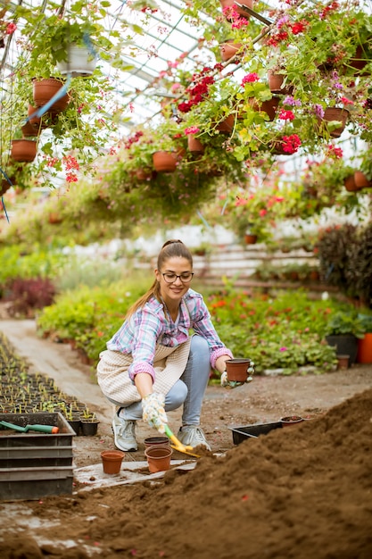 View at young woman working in flower garden