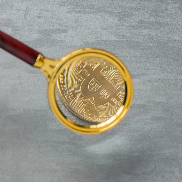 Viewing and the increase in bitcoin through a magnifying glass. electronic money