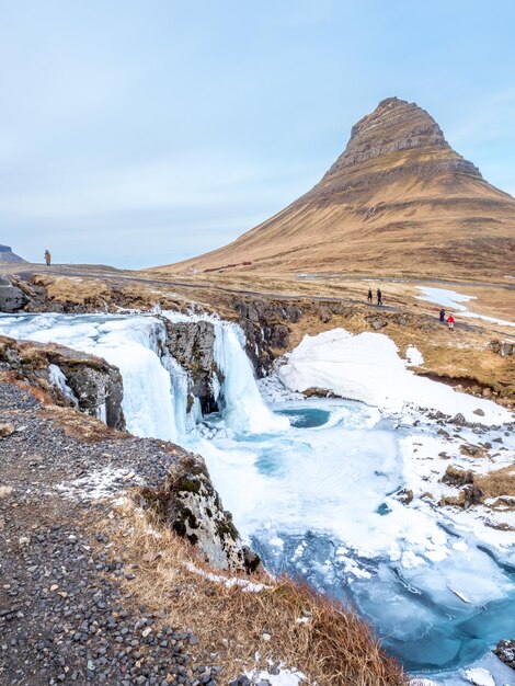 Viewpoint of Kirkjufell mountain and Kirkjufellfoss waterfall in Iceland water freeze to be ice