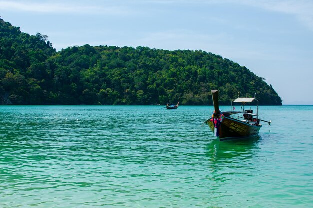 Photo views of the islands of thailand and turquoise water rocks yachts or boats