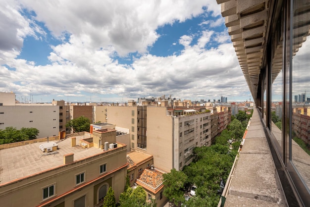 Views of the Madrid skyline from a penthouse apartment dedicated to vacation rental a day with summer clouds