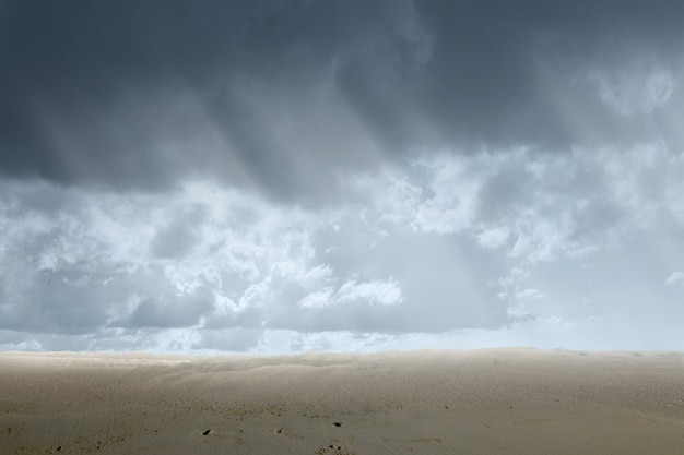 Views of sand dune with a dramatic sky