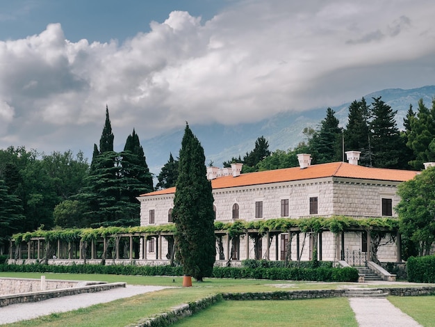 Villa milocer with a pergola covered with green ivy and a luxurious garden