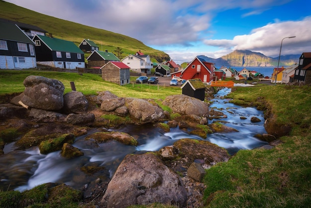Village of Gjogv on Faroe Islands with colourful houses and a creek