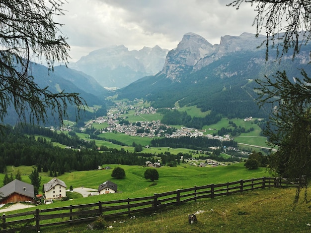 Village on green landscape amidst mountains