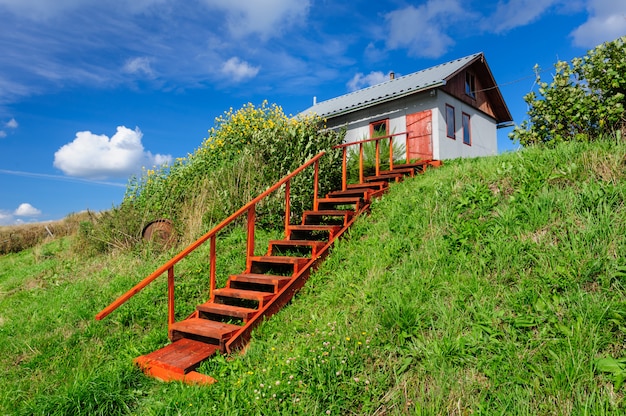 Village house at hill, with stairs