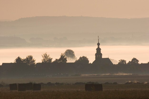 Village in morning fog Rossdorf Hesse Germany