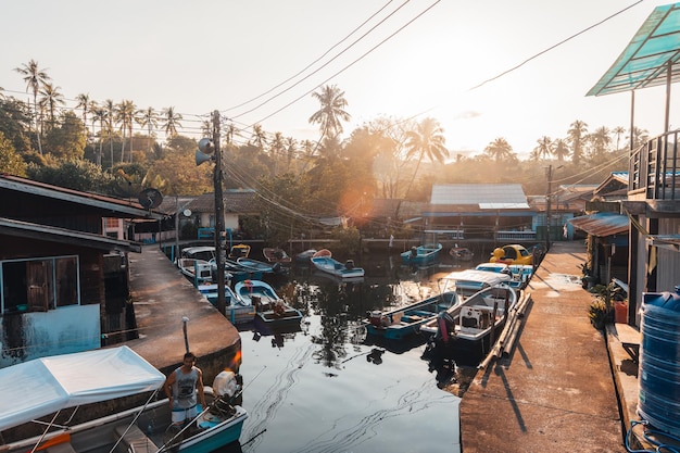 Village and pier in the canal next to the sea in the morning