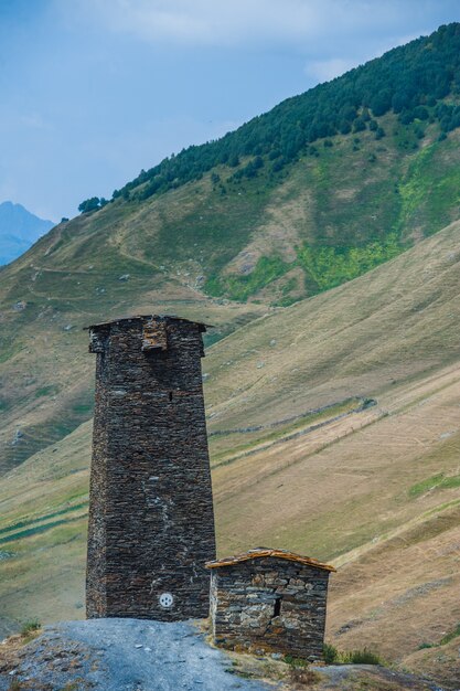 Village Ushguli landscape with massive rocky mountains Bezengi wall, Shkhara on the background in Svaneti, Georgia