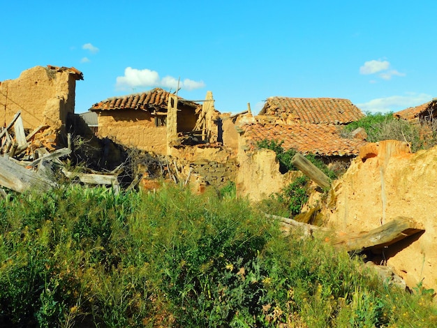 A village with a blue sky and a few small houses.