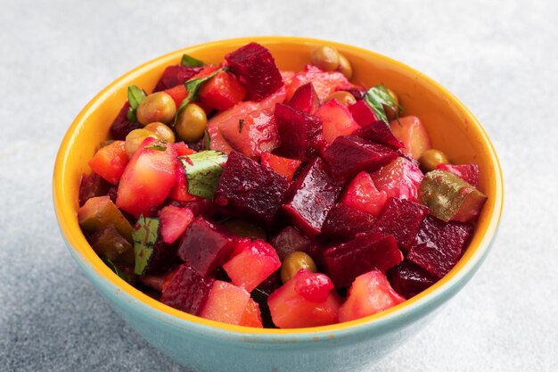 Vinaigrette with beetroot and boiled vegetables traditional Russian homemade salad Serving bowls with a cold snack on the table copy space