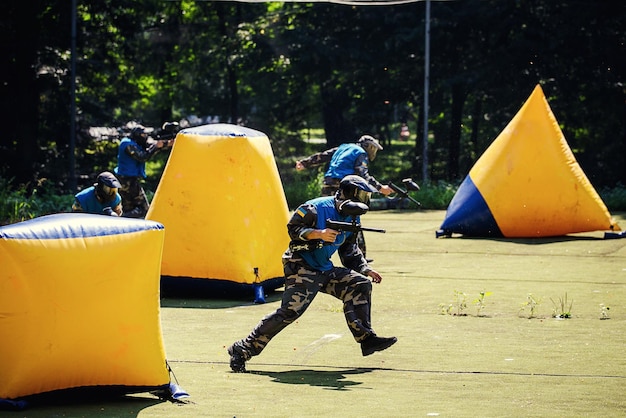 VinnitsaUkraine August 222016Young man Paintballerin protective uniform and mask in extreme process of paintball game