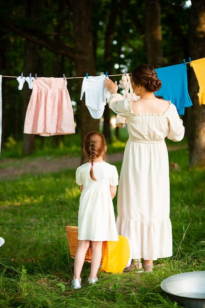 Vinnytsia Ukraine July 18 2022 Mother and daughter in white dresses spend time together in the summer