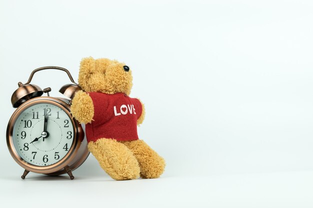 Vintage alarm clock and a little teddy bear