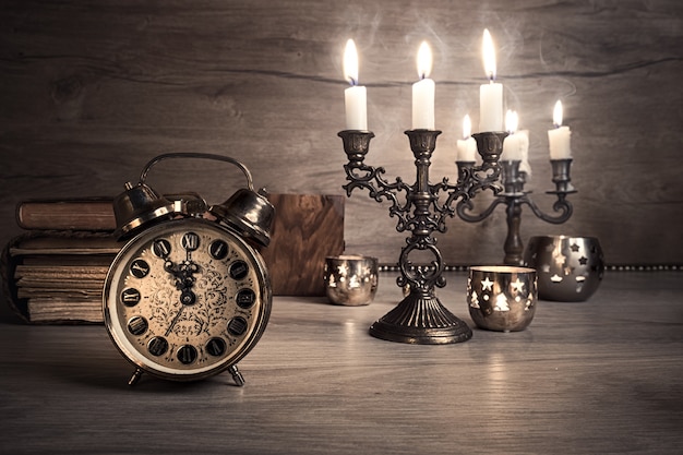 Vintage alarm clock showing five to twelve, toned image