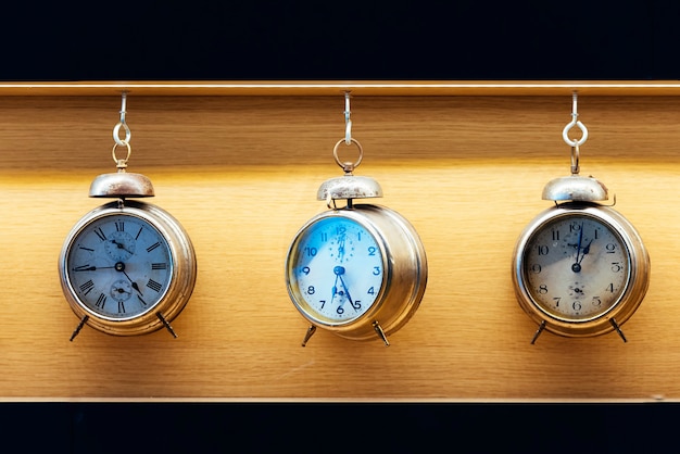 Vintage alarm clock on wood background. Time Concept.