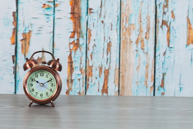 Vintage alarm clock on wood background 