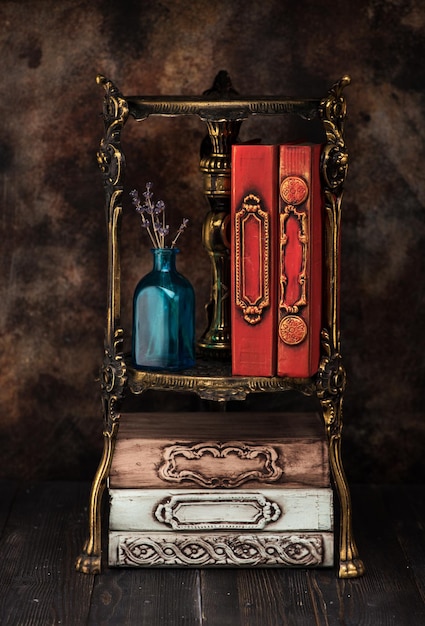 Vintage antique books on a bronze shelf bookcase