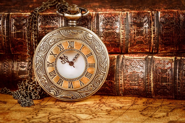 Vintage Antique pocket watch on the background of old books