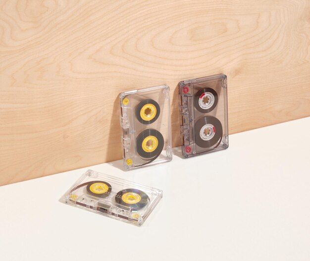 Vintage audio cassettes near the wooden wall Technology concept