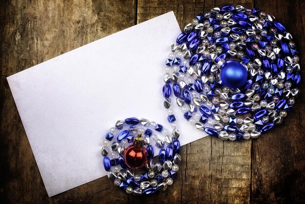 Vintage background christmas ball toy on a wooden table and a blank sheet of paper