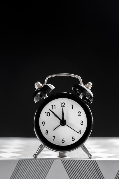 Vintage background with retro alarm clock on table