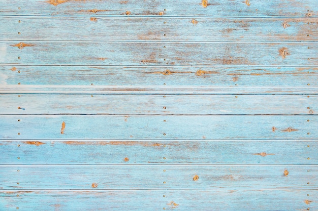 Fondo di legno d'annata della spiaggia - vecchia plancia di legno stagionata dipinta nel colore del mare del turchese o del blu.