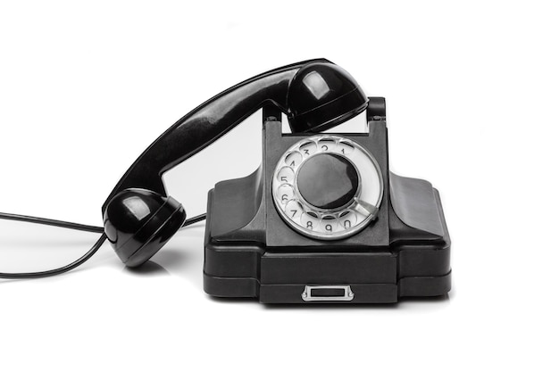 Photo vintage black telephone on a white bachground