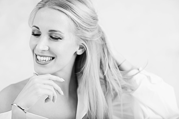 vintage black and white photo of a girl with professional make-up / strict make-up on the face of a beautiful professional model in a beauty salon