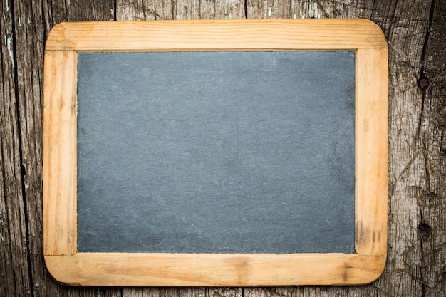 Vintage blackboard on wooden background