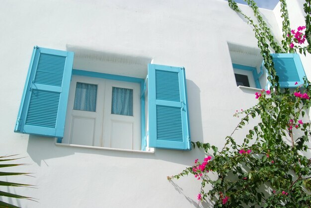 Vintage blue window on the white wall