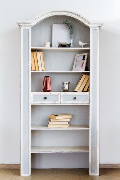 Vintage bookcase cupboard against a white wall background