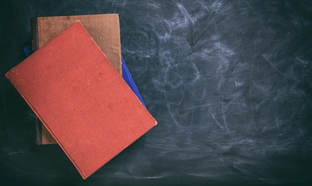 Photo vintage books on a blackboard copy space