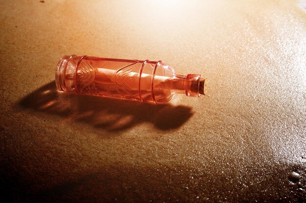 Vintage bottle with message on the beach