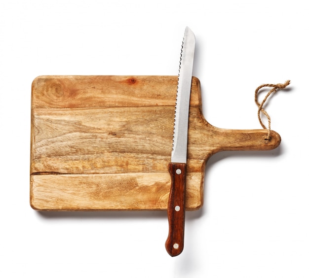 Vintage bread knife on wooden board isolated