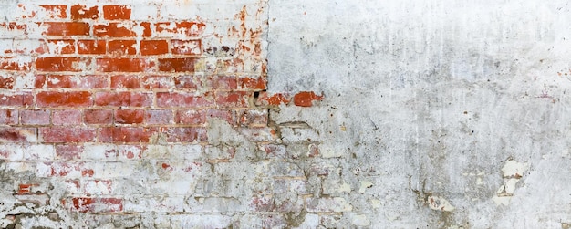 Vintage brick rough rustic wall with cracked plaster