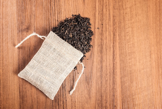 Vintage burlap with tea on wooden background