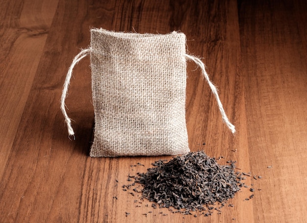 Vintage burlap with tea on wooden background