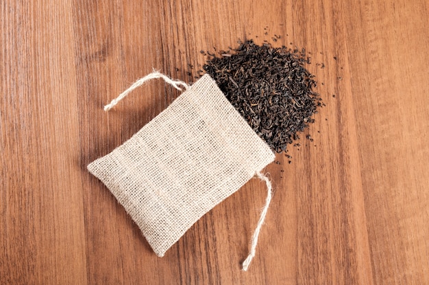 Vintage burlap with tea on wooden table