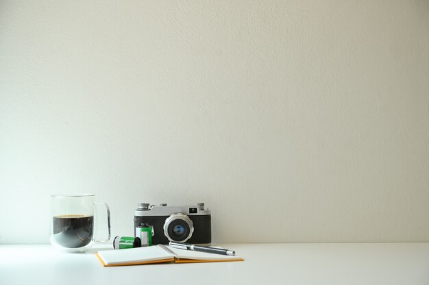 Vintage camera and film with coffee on table 