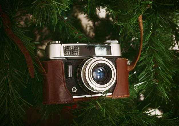 Vintage camera hanging on artificial christmas tree